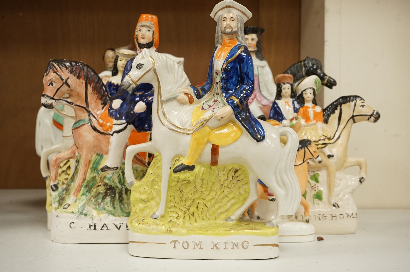 Thirteen Staffordshire pottery equestrian figures to include Tom King, Dick Turpin and Sir Colin Campbell, largest 28cm high